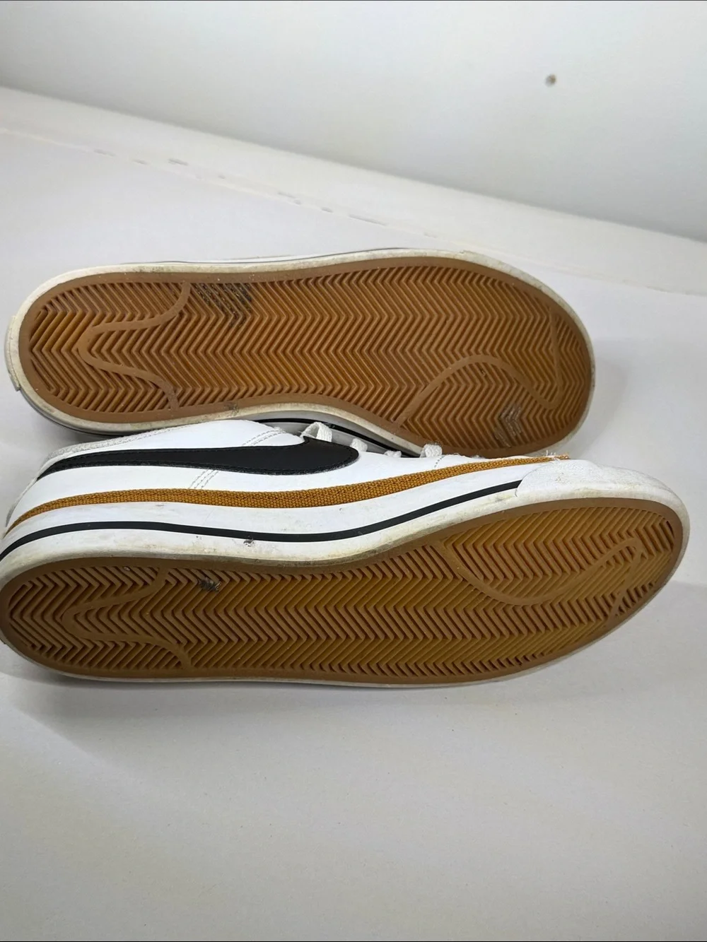 Nike White Low-Top Sneakers with Black Swoosh and Brown Trim